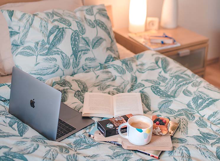 image of laptop on a bed
