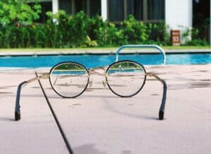 Pair of glasses overlooking a pool